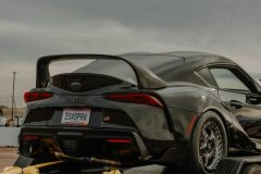 High-Performance Sports Car Securely Towed on Flatbed Trailer